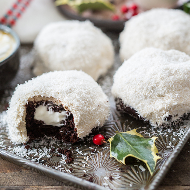 Coconut snowball cookies with a surprise chocolate and cream center, perfectly capturing a wintery dessert scene.