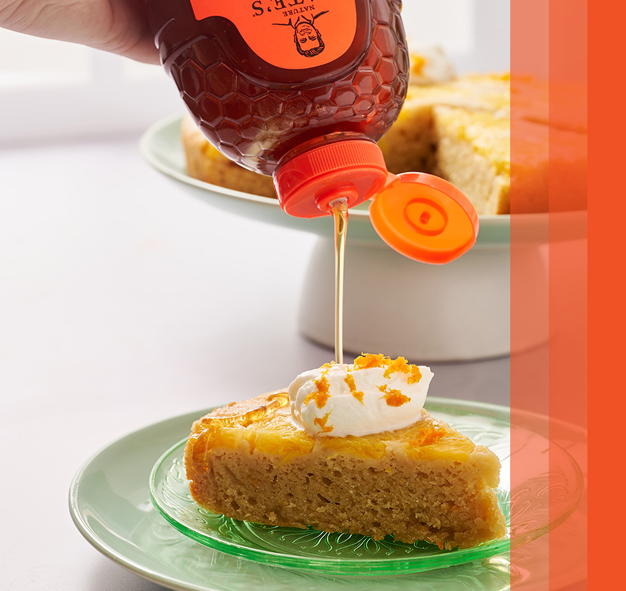 Drizzling honey on honey ginger carrot cake from a Nate’s honey bottle.