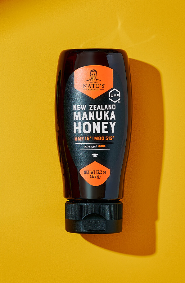 Nate's New Zealand Manuka honey bottle centered on a yellow background.
