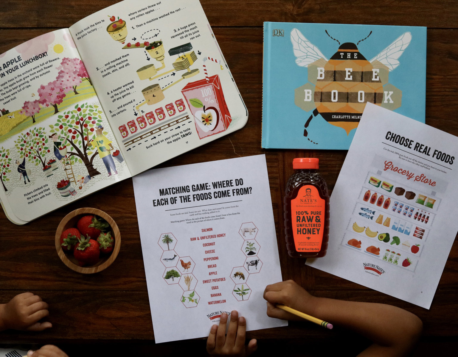 Children's educational activity about bees and food with a Nate's honey bottle, on a wooden table.