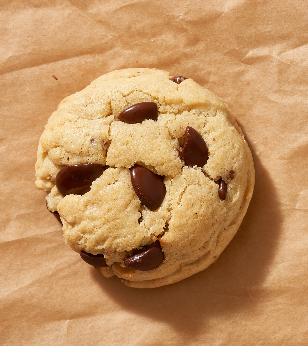 Chocolate chip cookie made with Nate's honey on brown paper.