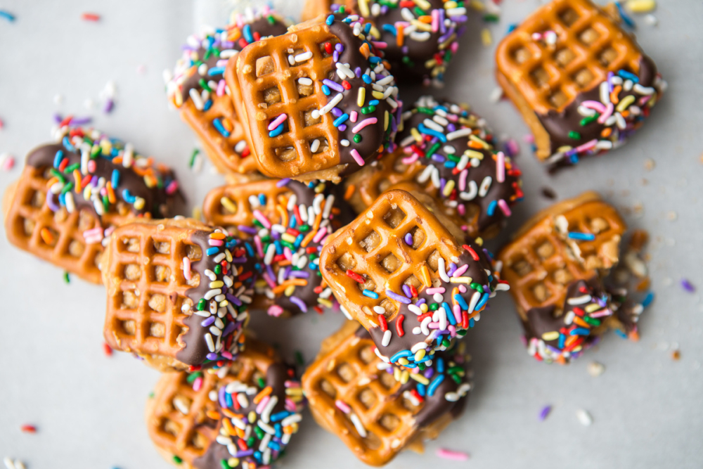 Chocolate-dipped waffle pretzels with colorful sprinkles on top. Chocolate-dipped waffle pretzels
with colorful sprinkles on top.