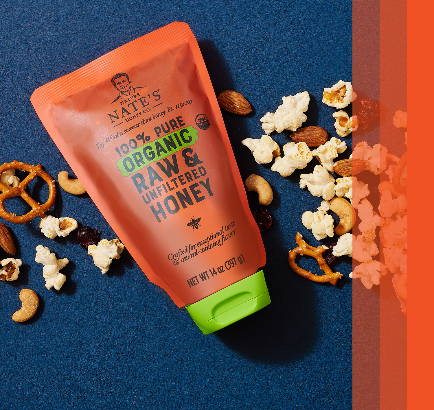 Nate's organic pouch on a blue background with pretzels and popcorn in the scene.