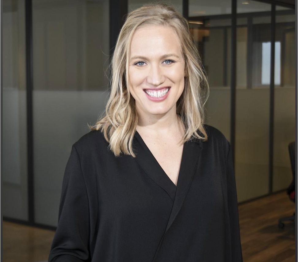 Nate's senior vice president of marketing and innovation standing in an office environment.