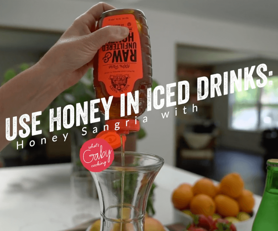 Hand pouring Nate's honey into a jug with text USE HONEY IN ICED DRINKS: Honey Sangria.